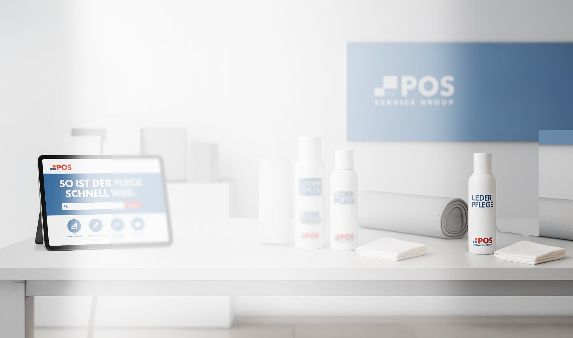 Une tablette affichant un écran est posée sur une table blanche avec plusieurs bouteilles blanches, des chiffons et un tapis enroulé. Un panneau bleu et blanc du groupe POS Service est visible sur le mur à l'arrière-plan.